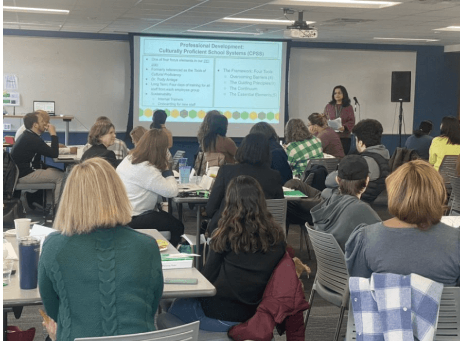 Someone presenting on a screen with an audience watching