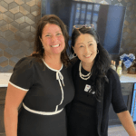 Two women smiling into the camera