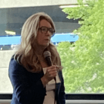 Shana Finnegan speaking into a microphone