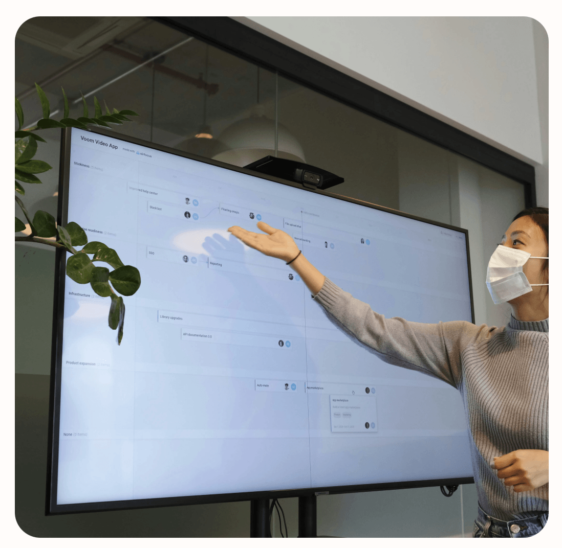 A woman pointing to a projector screen