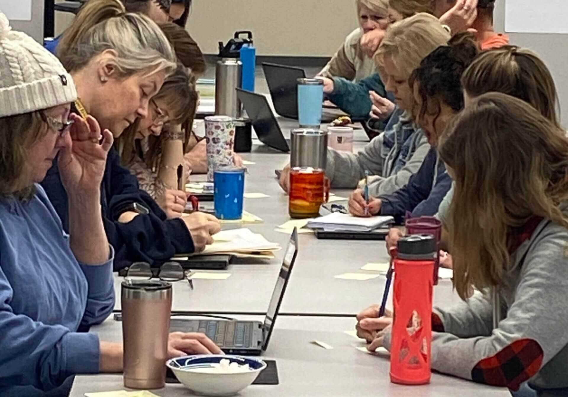 People sitting at a table writing