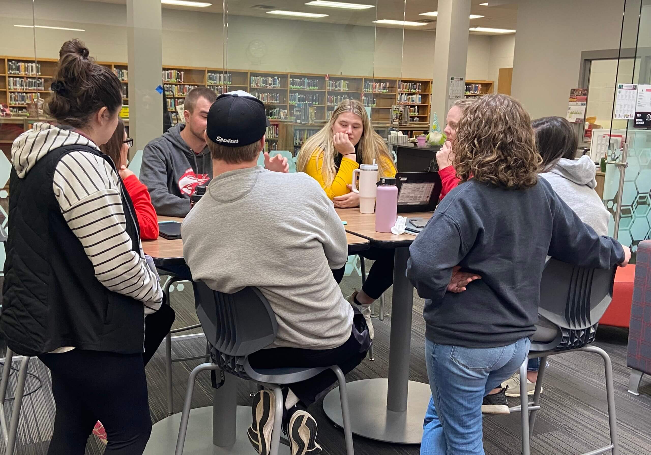 Men and women sitting around a table talking