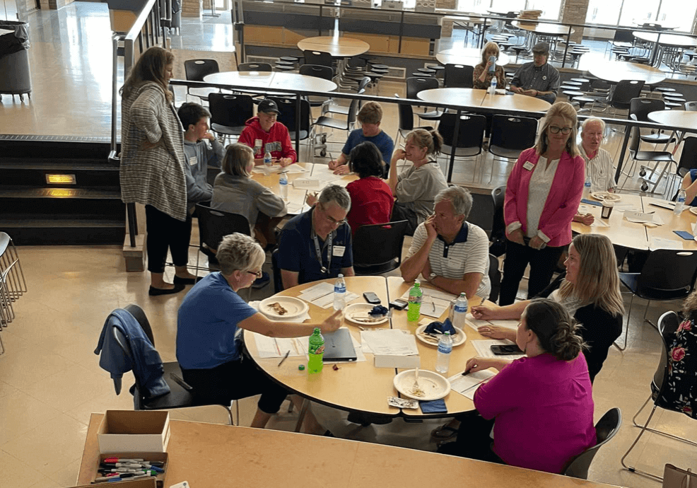 A group of teachers sitting around a table talking