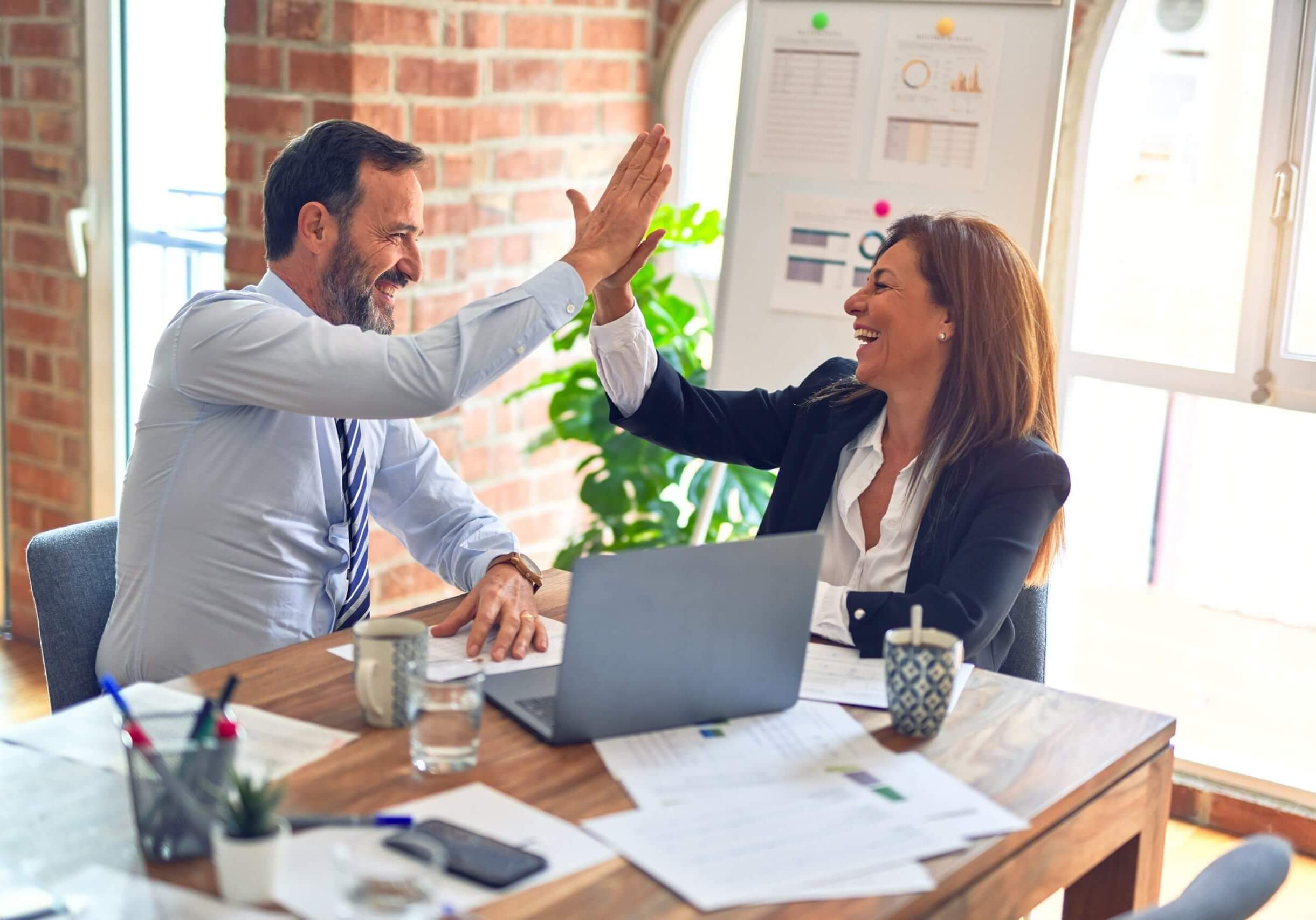 A man and woman giving a high five